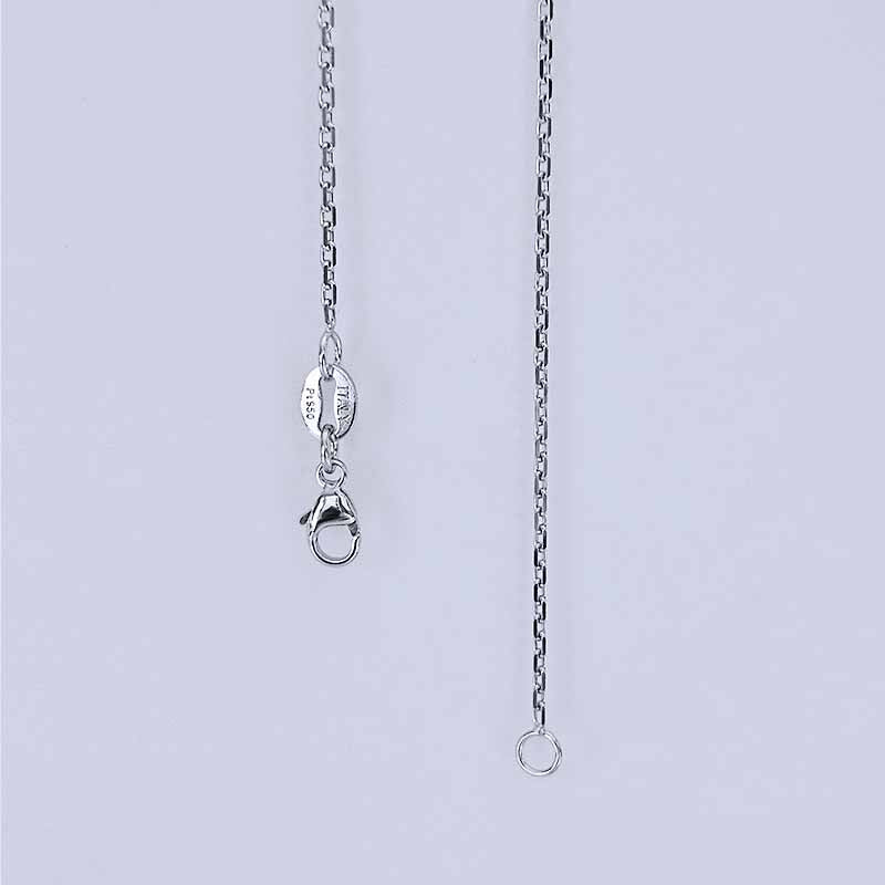 Platinum chain necklace on a light gray background