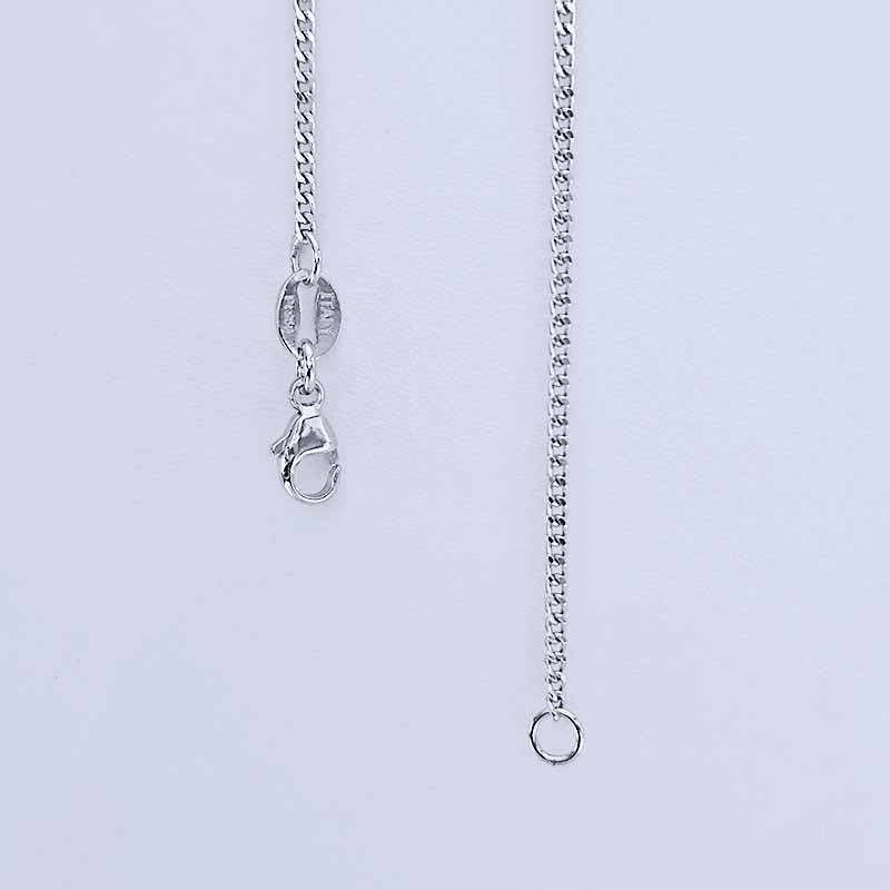 Close-up of a Platinum chain necklace on a light gray background