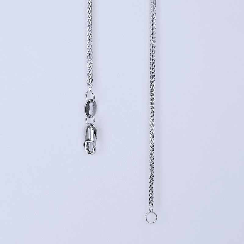 Platinum chain necklace on a light gray background