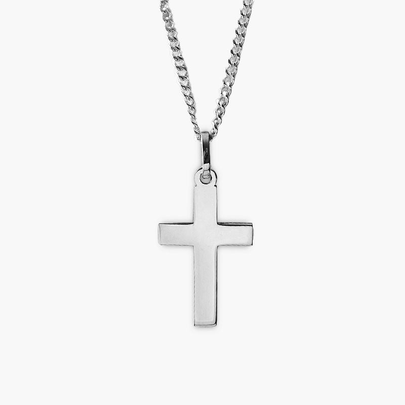 Silver cross pendant on a chain against a white background