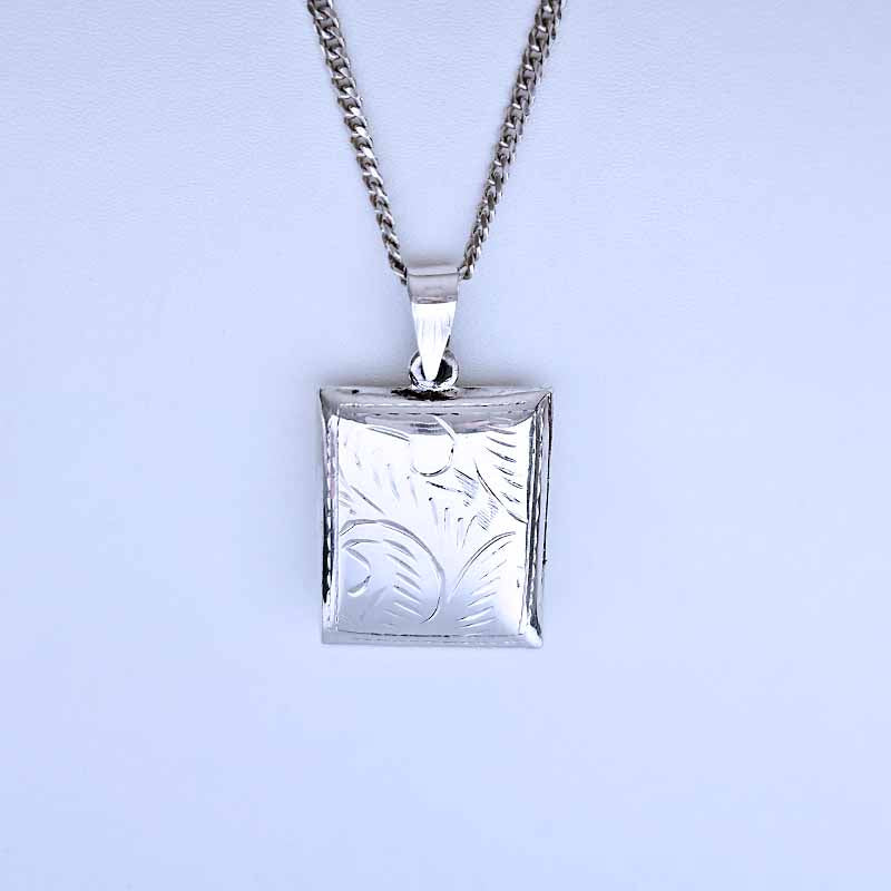 Silver square pendant necklace on a light gray background