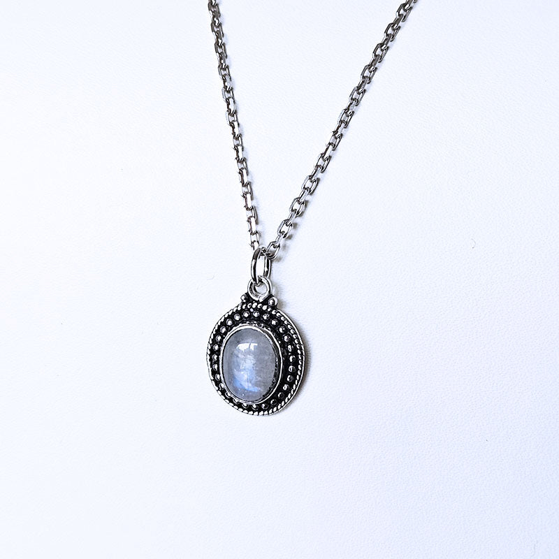 Silver necklace with a pendant on a white background