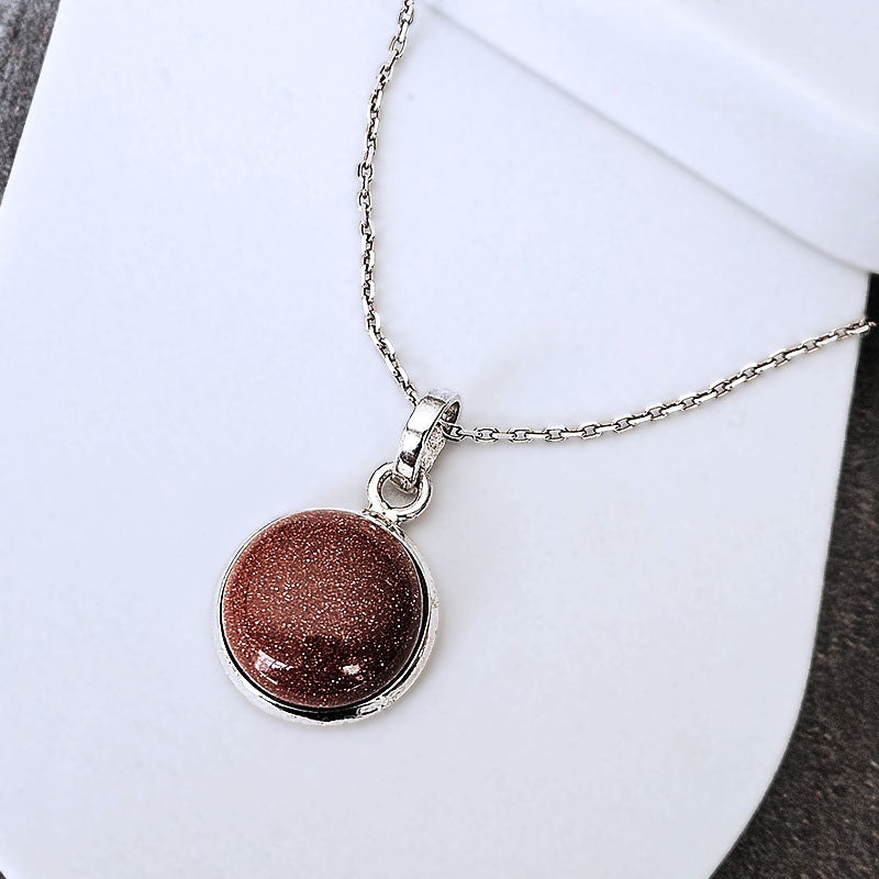 Necklace with a round brown pendant on a white background