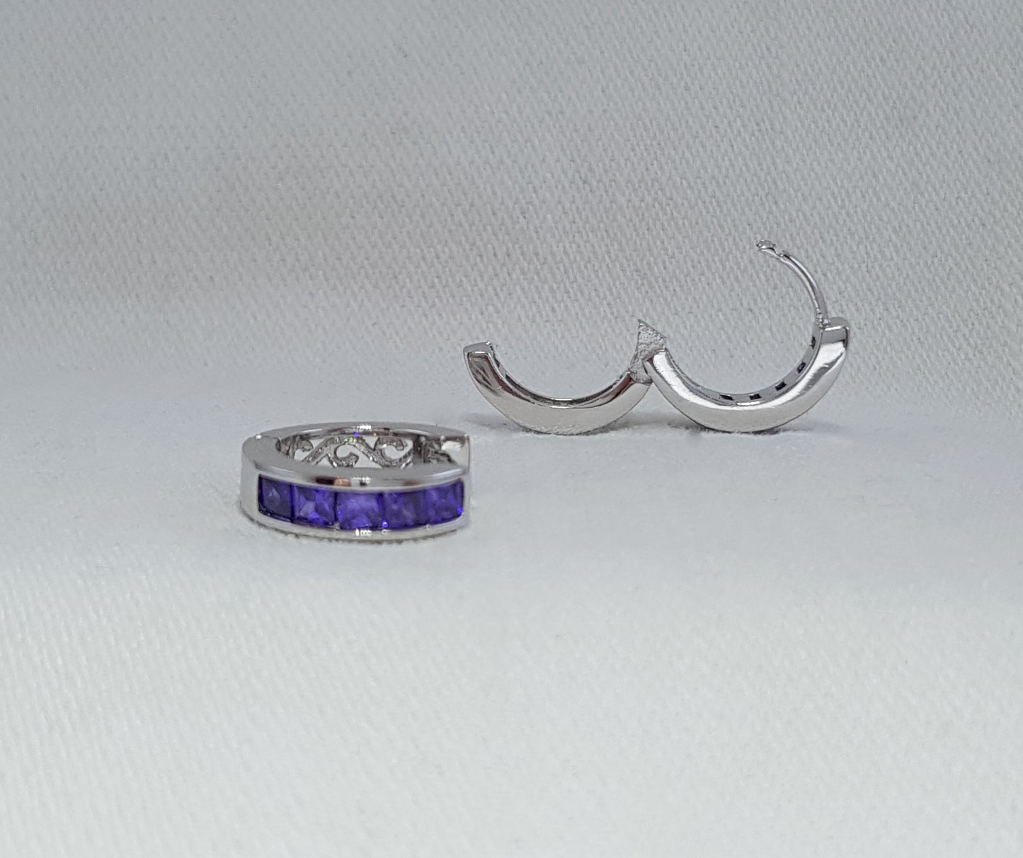 sterling silver huggies with purple cubic zirconia stones