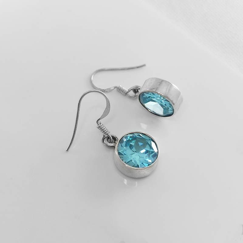 Sterling silver round topaz earrings with a faceted stone cut