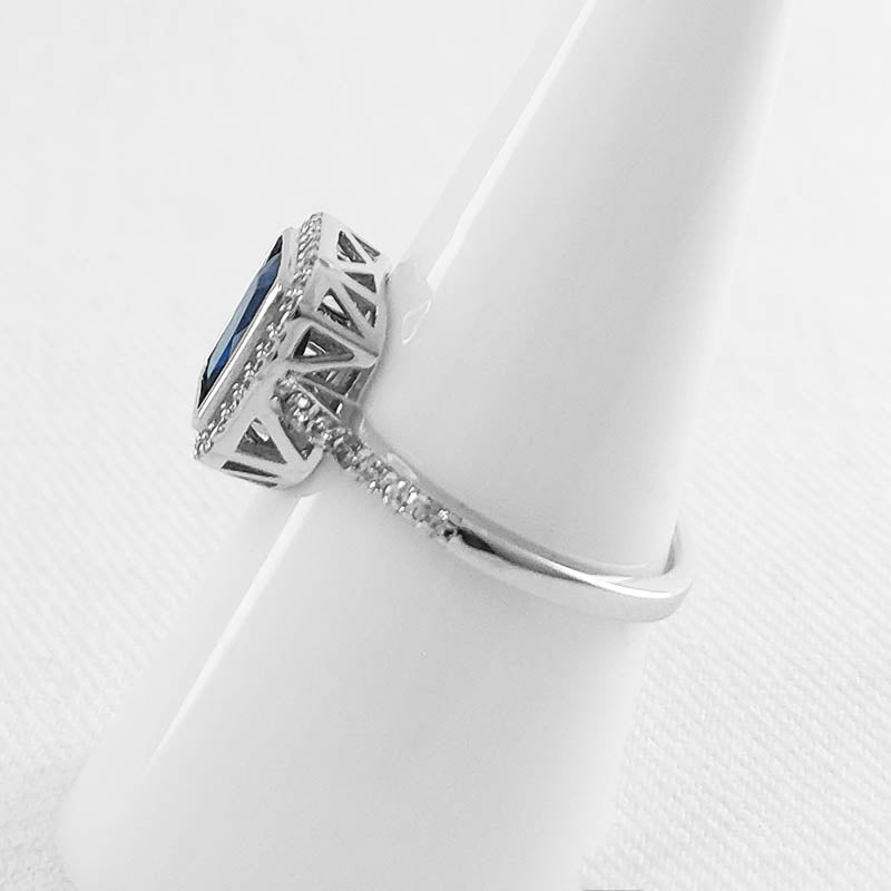 sterling silver ring with a blue rectangle-shaped CZ stone.