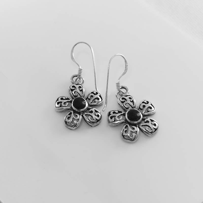 Sterling silver flower earrings with a black stone inlay
