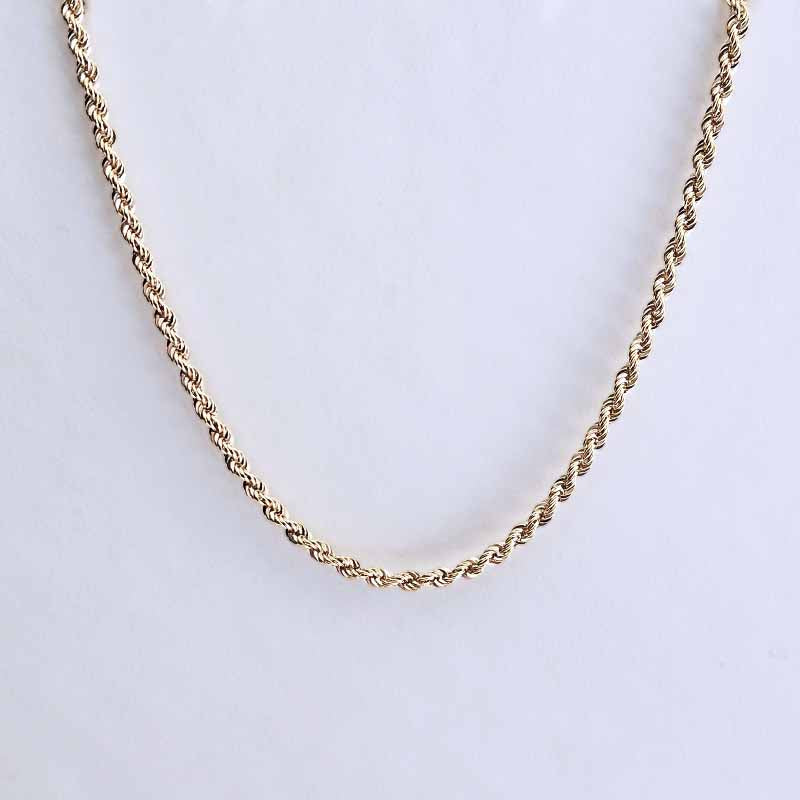 A gold twisted rope chain necklace displayed against a plain white background.