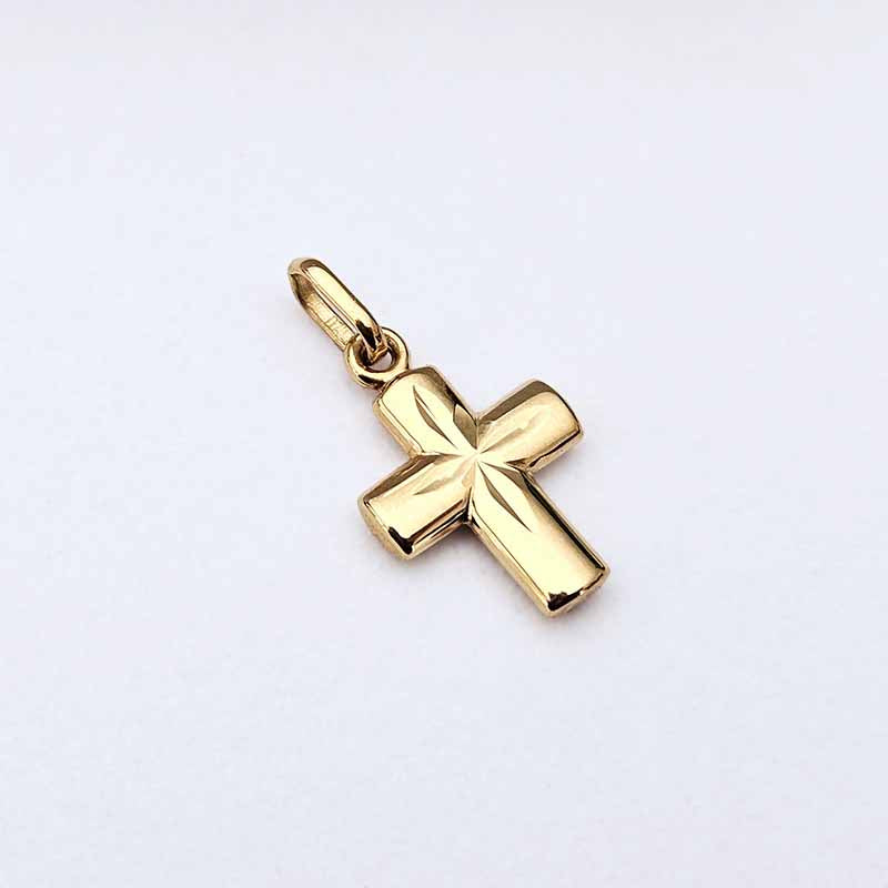 A polished yellow gold cross pendant with a textured, ribbed surface and a smooth top loop, shown on a plain white background.