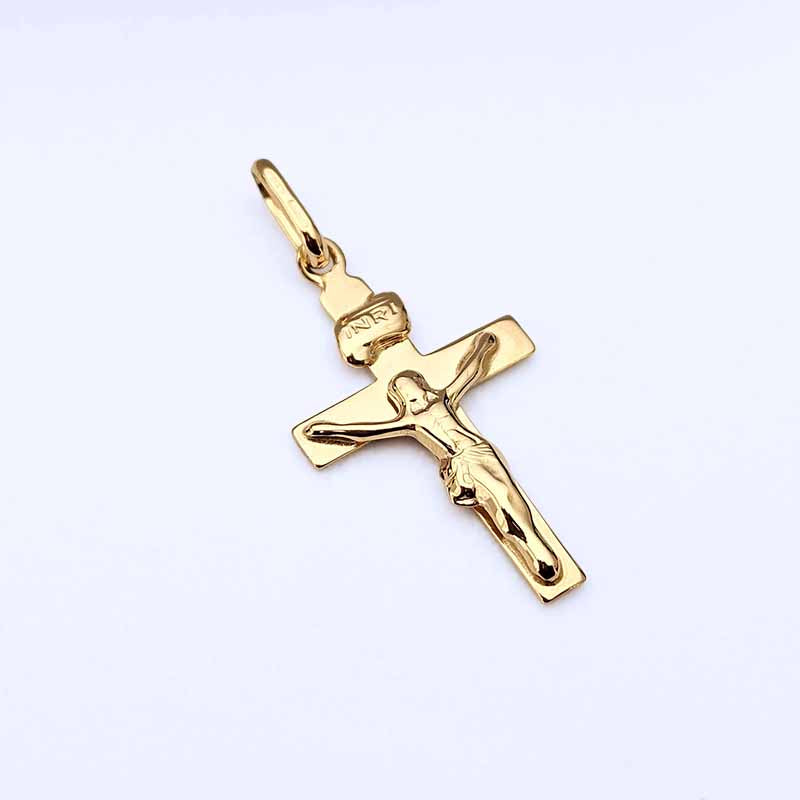 A polished yellow gold crucifix pendant featuring a detailed figure of Jesus Christ on a cross with an 'INRI' inscription, shown on a plain white background.