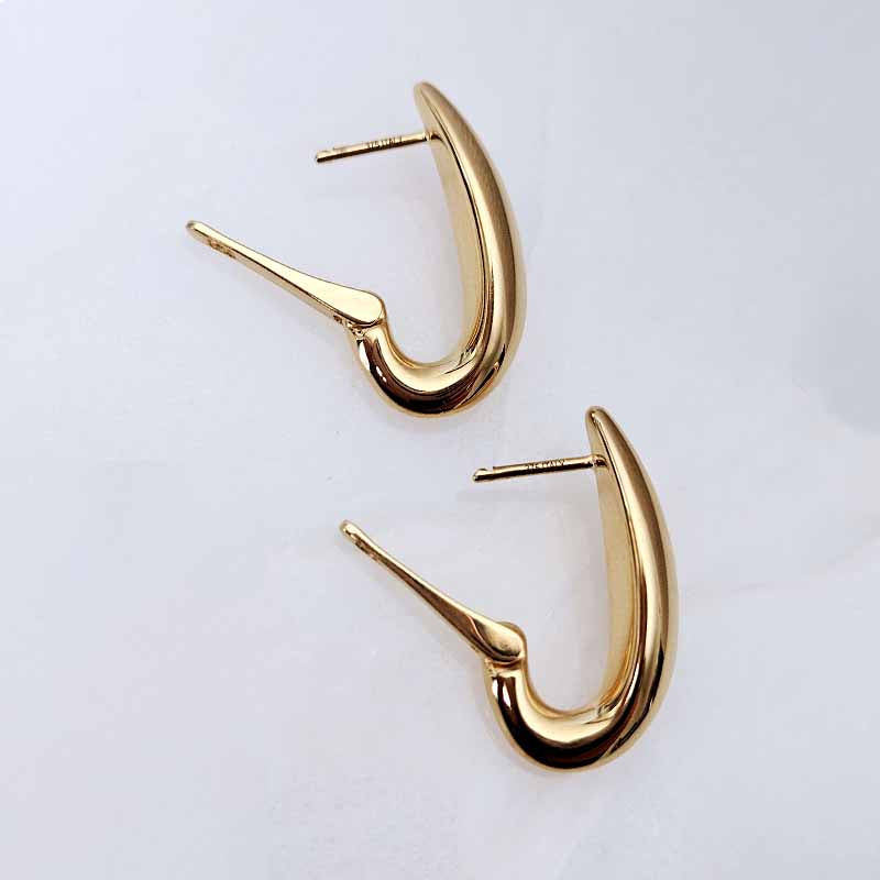 A pair of gold crescent-shaped hoop earrings with post-back closures, displayed on a clean white background.
