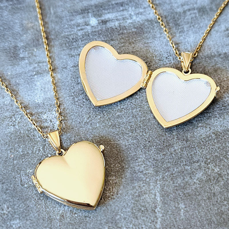 Gold heart-shaped locket on a textured surface