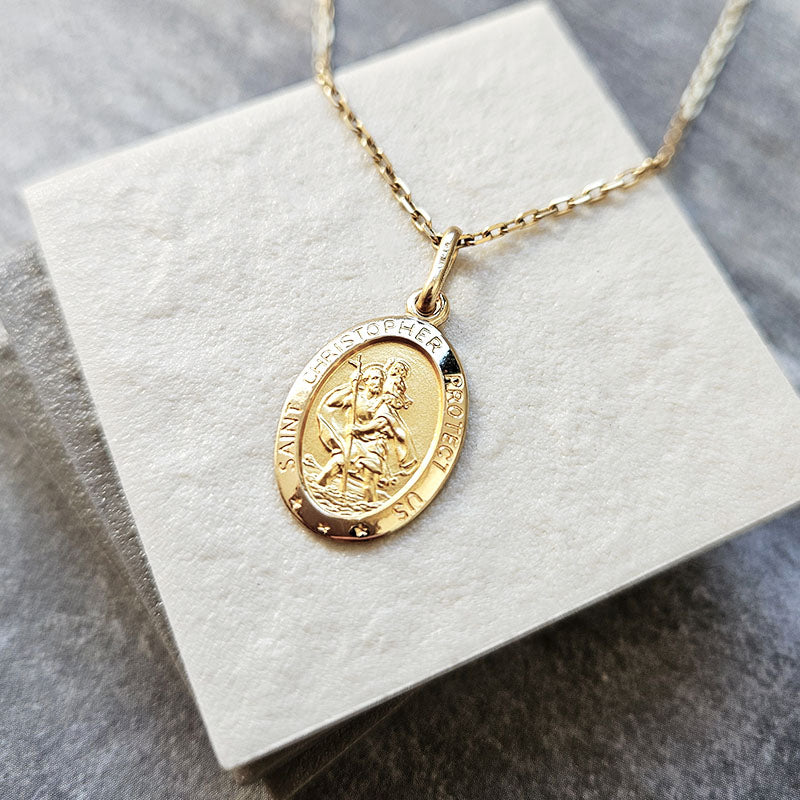 Gold necklace with a pendant on a white card