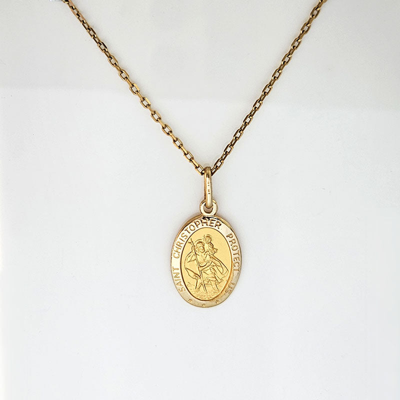 Gold necklace with a pendant on a white background