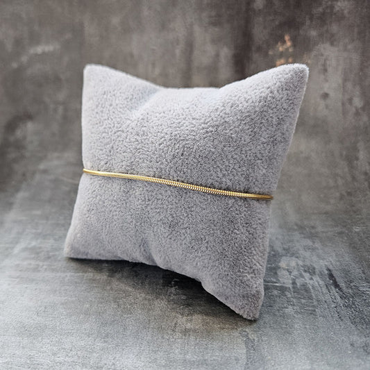 Gold Snake Bracelet on a grey cushion