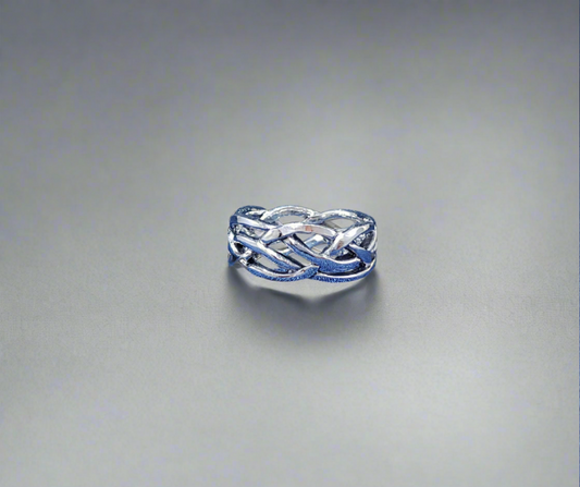 A broad Celtic weave ring displaying an intricate and interlacing pattern inspired by Celtic artistry.