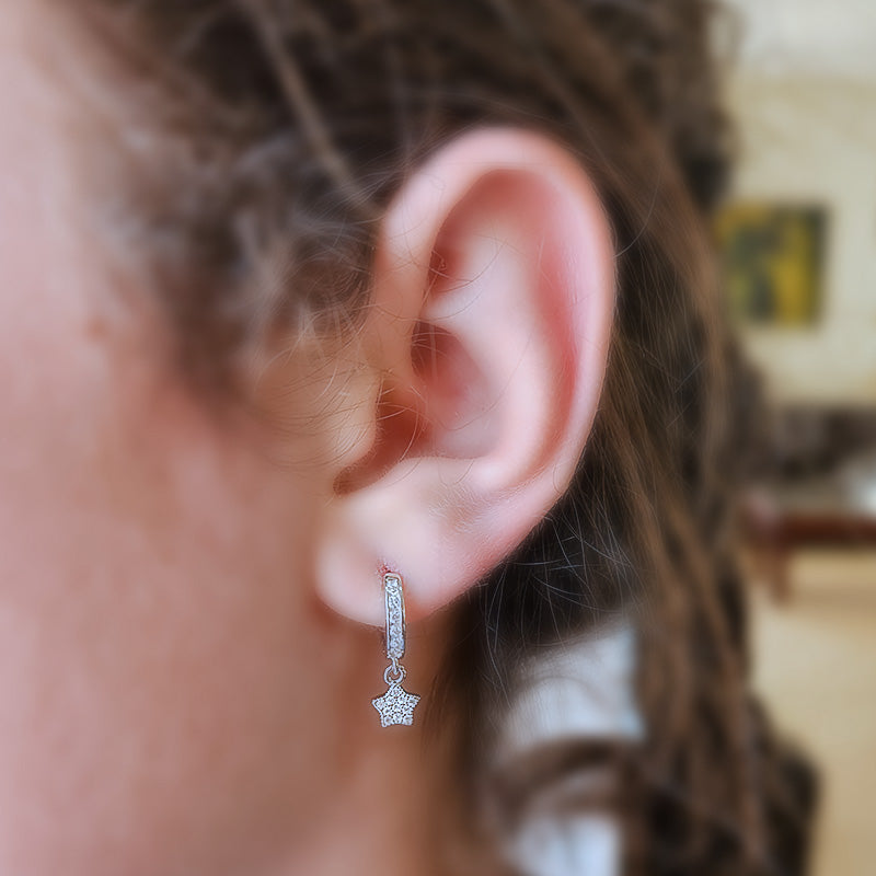 Sterling Silver huggie earrings with a cz dangling star