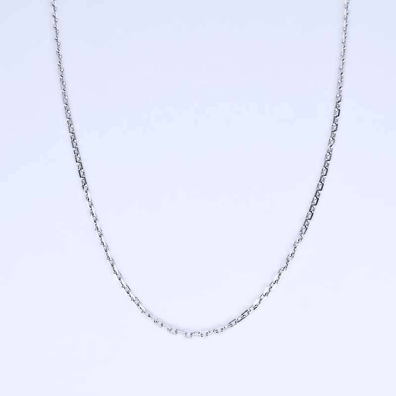 Platinum chain necklace on a light purple background