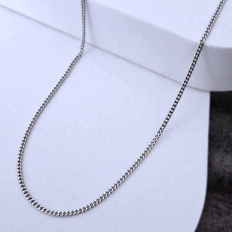 Platinum necklace on a white surface