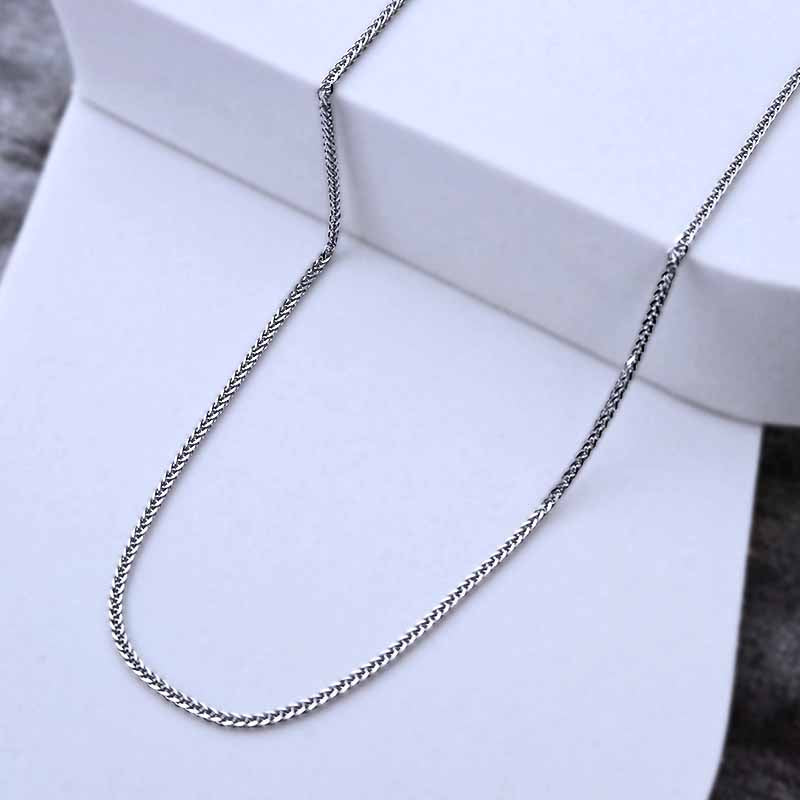 Platinum chain necklace on a white stand