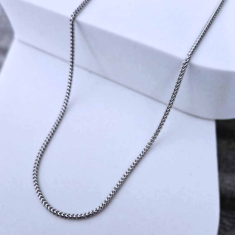 Platinum chain  necklace on a white stand