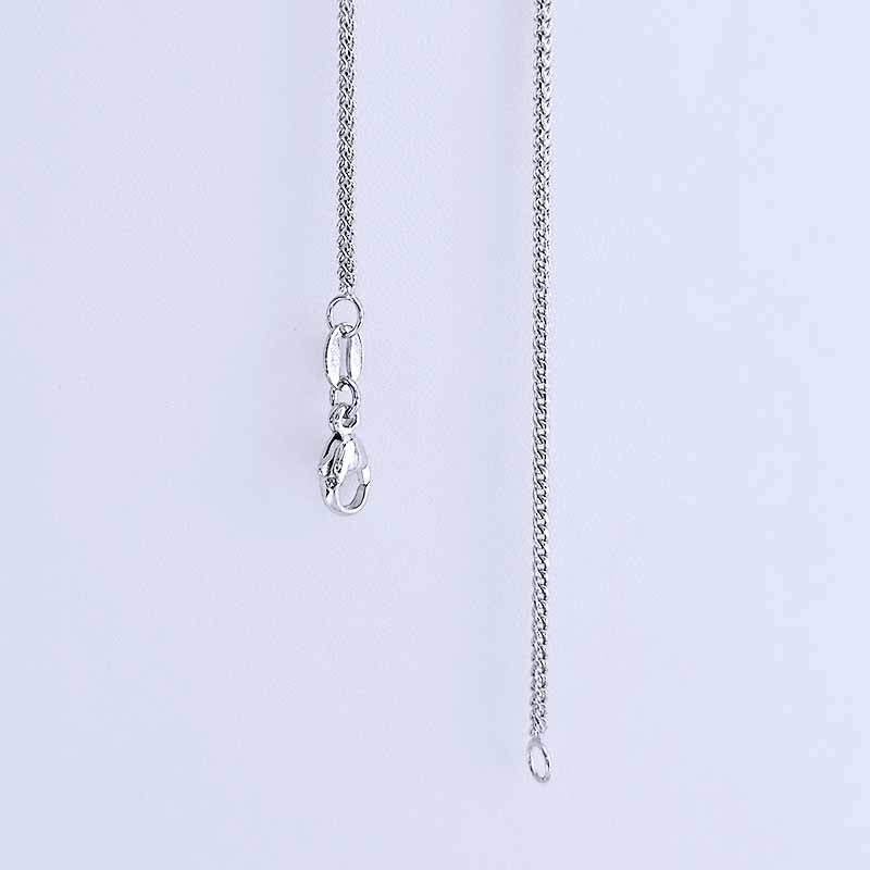 Platinum chain necklace on a light gray background
