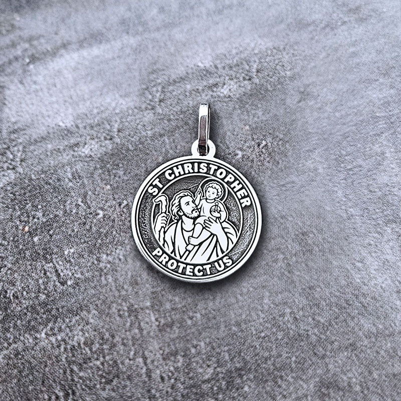Silver St. Christopher pendant on a textured gray background