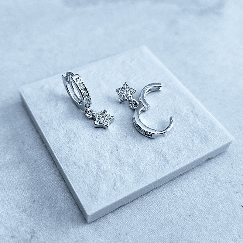 Sterling Silver huggie earrings with a cz dangling star