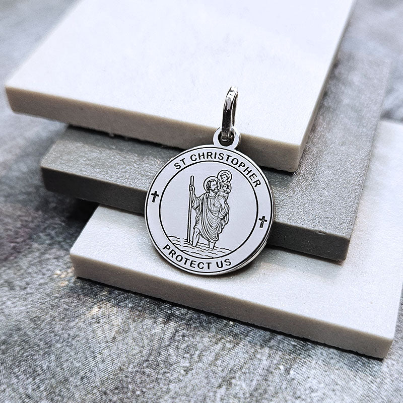 Silver St. Christopher pendant on a marble surface