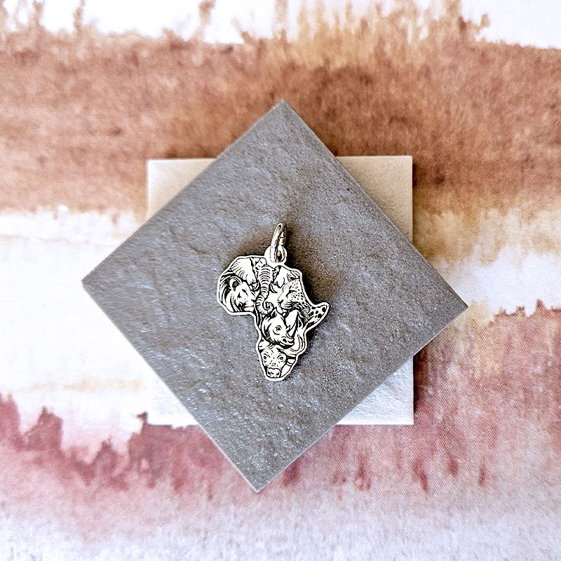 Africa with the faces of the Big 5 made with sterling silver on a stone surface