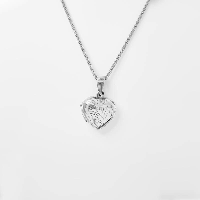 Small sterling silver heart locket with a silver necklace.