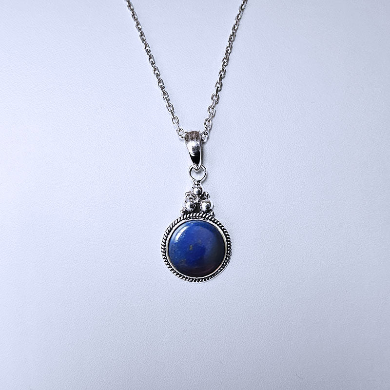 Necklace with a blue pendant on a light gray background