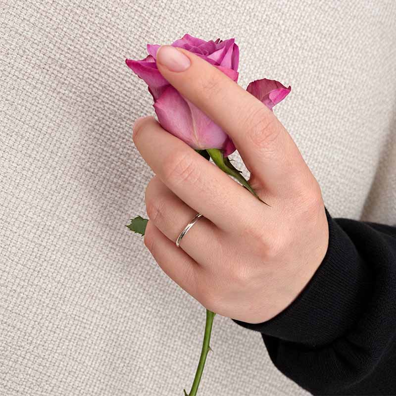 Sterling Silver Plain Band  on a woman's hand holding a rose