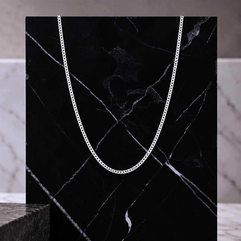 Sterling Silver curb chain - 1,2mm thickness on a black marble tile
