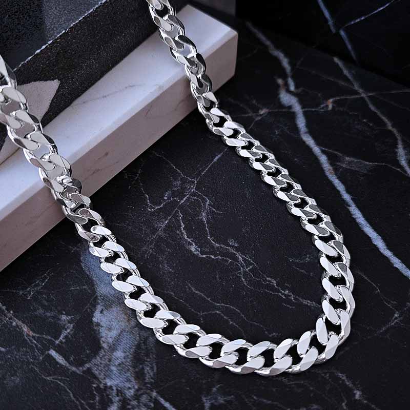 silver men's chain on a dark marble