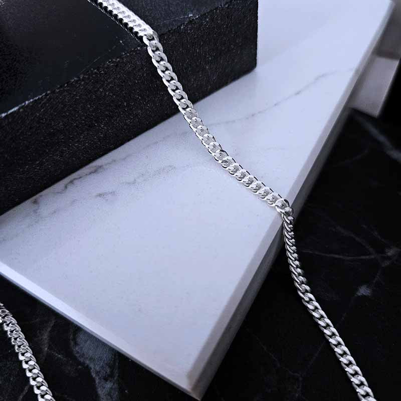 Sterling Silver Curb Chain on a white marble surface