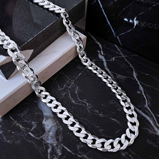 Chunky silver chain for men on a dark surface