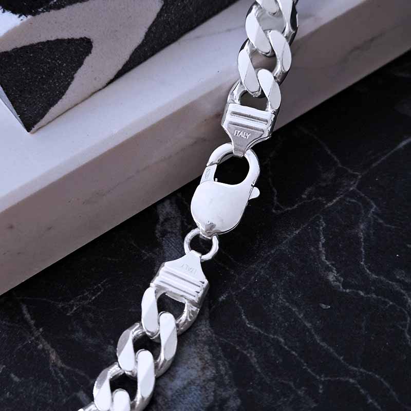 Italian clasp of a silver chain on a marble background
