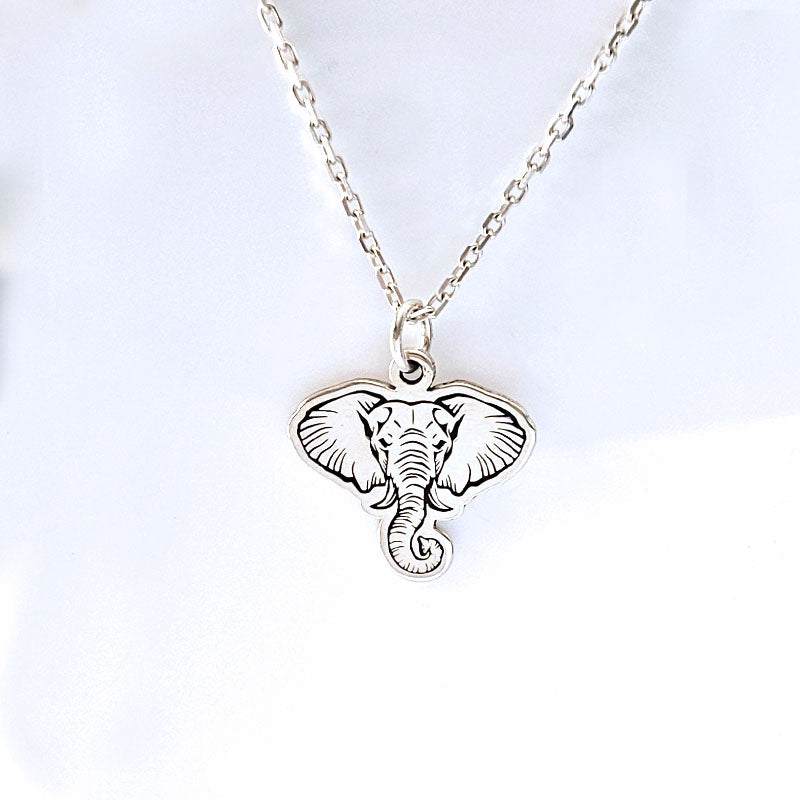 Silver elephant pendant necklace on a white background