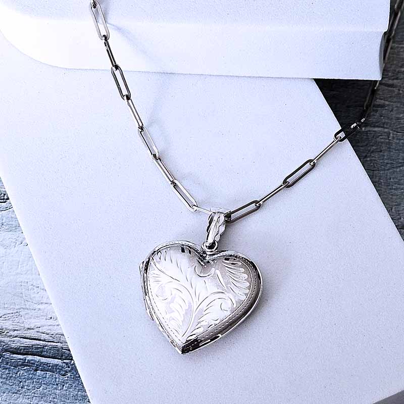 Silver heart-shaped pendant necklace on a white background