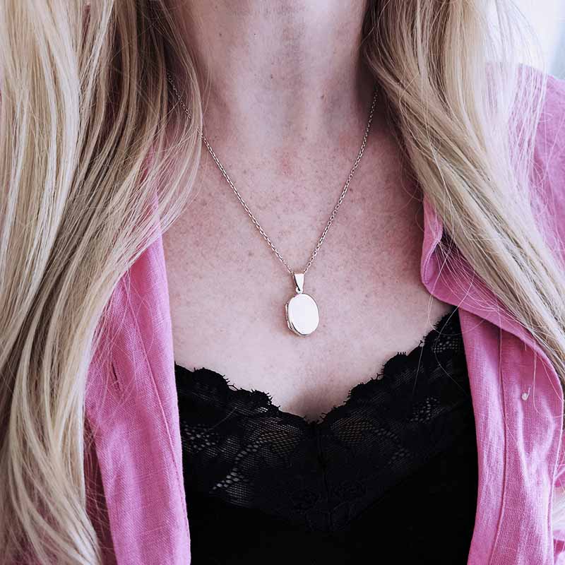 Silver Locket necklace on a womans neck