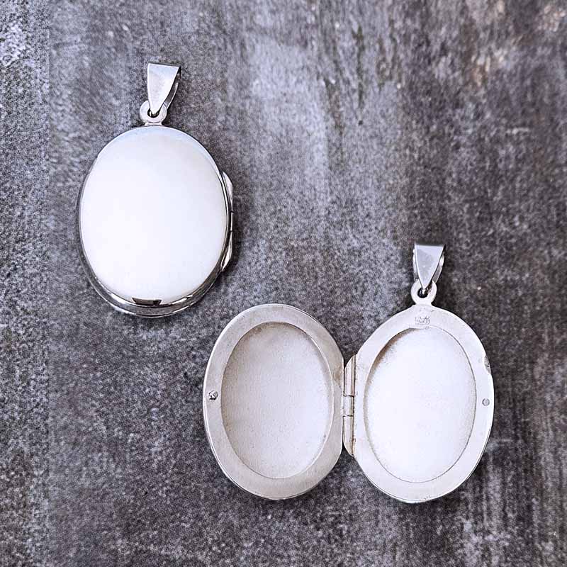 Silver locket on a textured gray surface