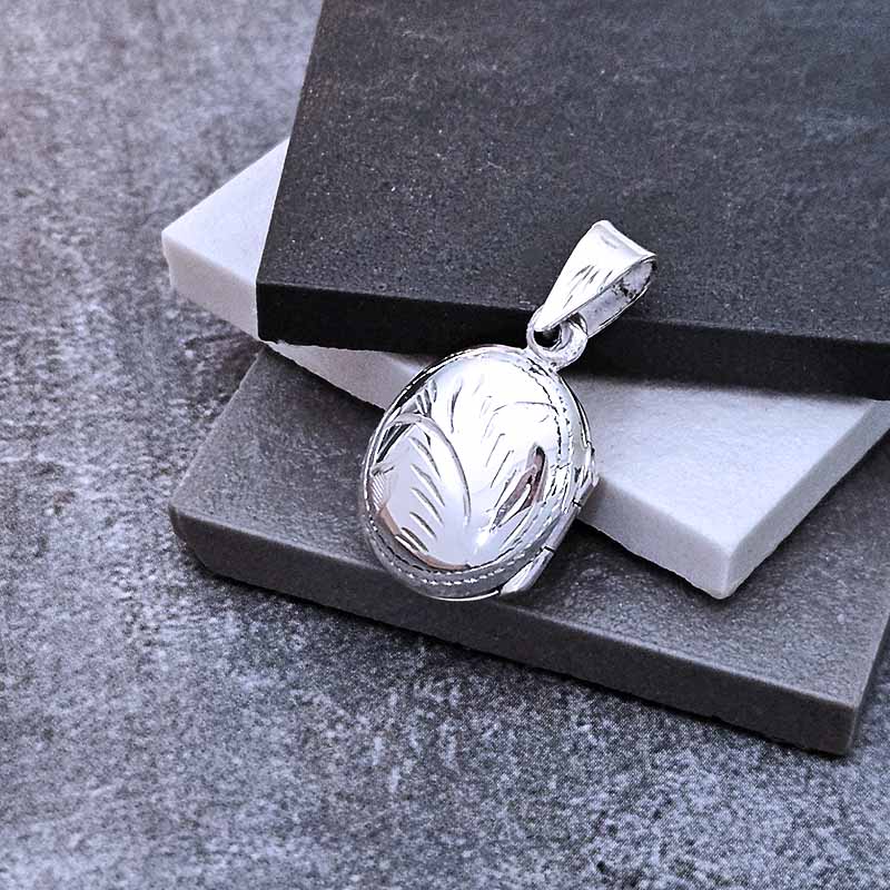 Silver pendant on a gray stone surface