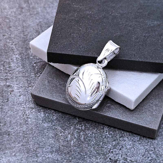 Silver pendant on a gray stone surface