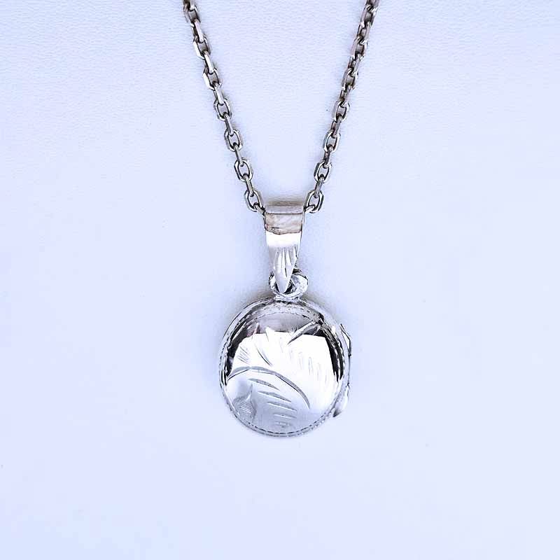 Silver pendant necklace on a light gray background