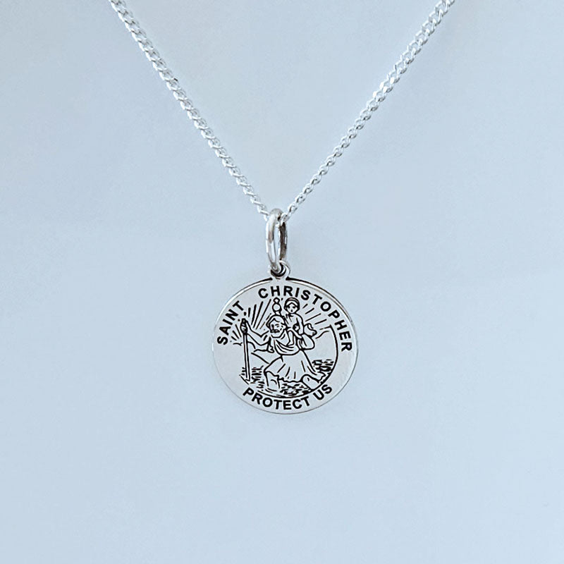 Silver Saint Christopher necklace on a light gray background