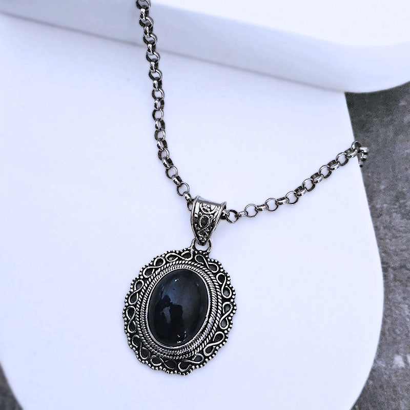 Silver necklace with a Labradorite  pendant on a white background