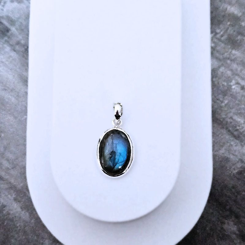 Sterling silver pendant with a labradorite stone on a white background