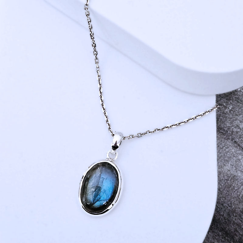 Sterling silver pendant with a labradorite stone on a white background