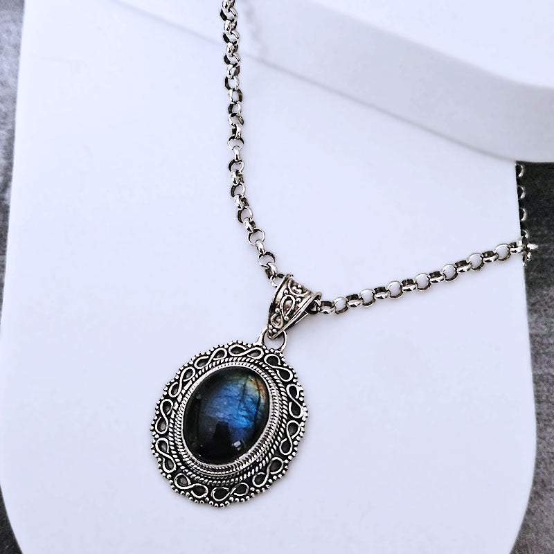 Necklace with a blue stone pendant on a white background